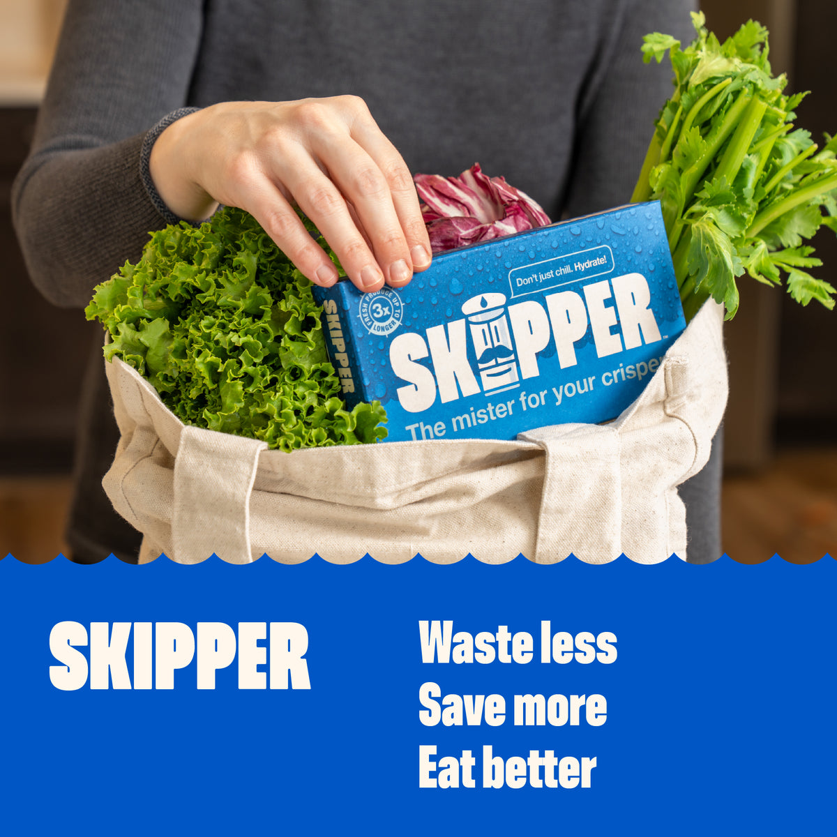 Hand placing a Skipper box into a canvas tote bag filled with fresh lettuce, celery, and radicchio. Text reads: Waste less, save more, eat better.